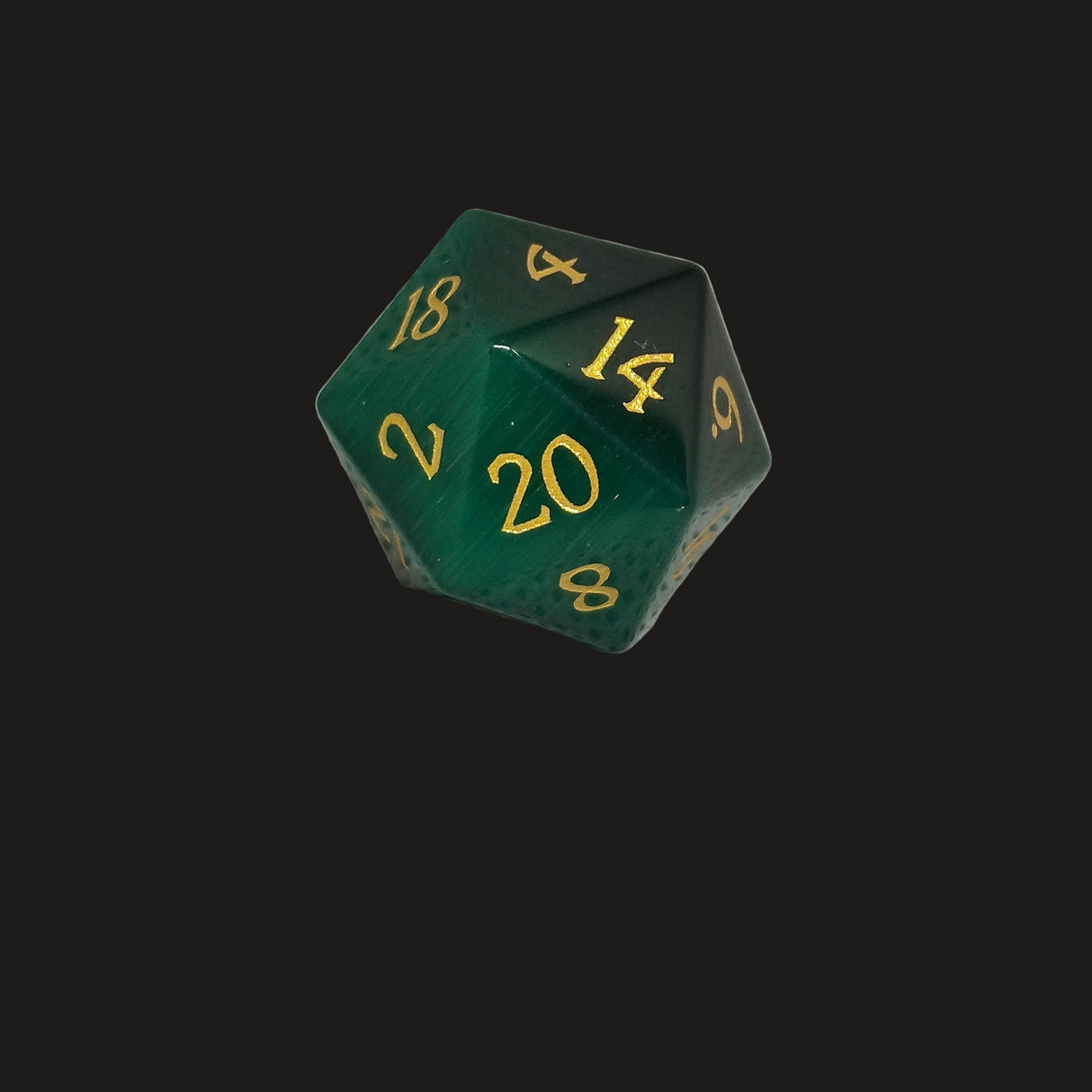 Green polyhedral dice with gold numbers