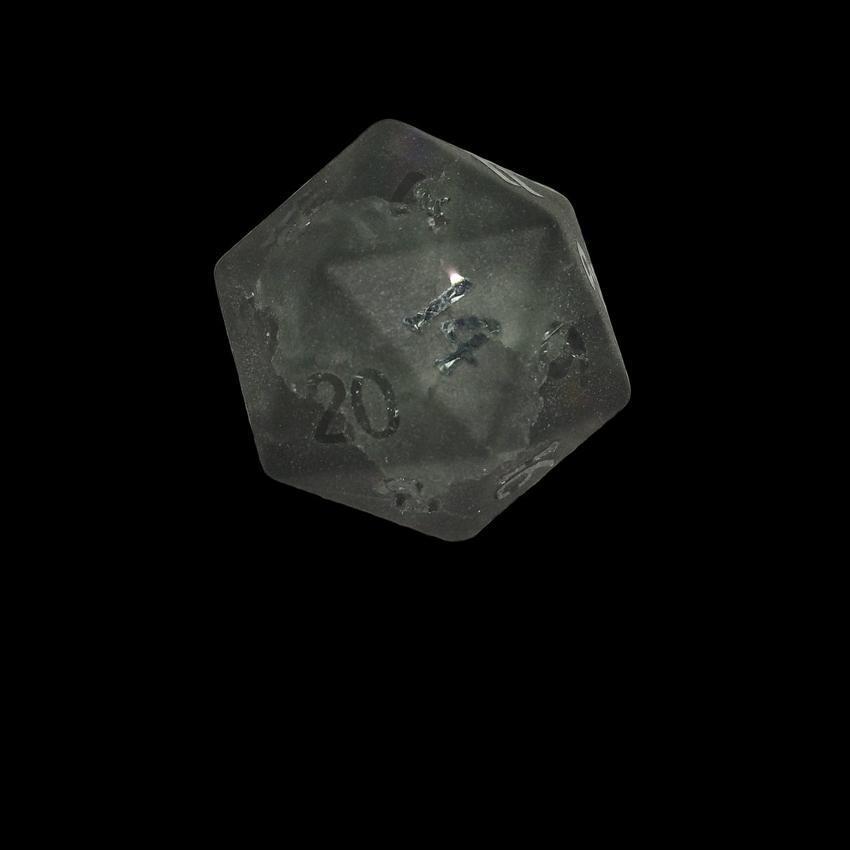 Black polyhedral glass die with '20' frosted