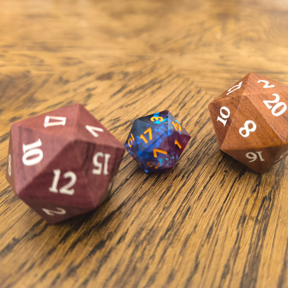 Oversized 33mm wooden D20 dice next to a regular sized D20 for scale