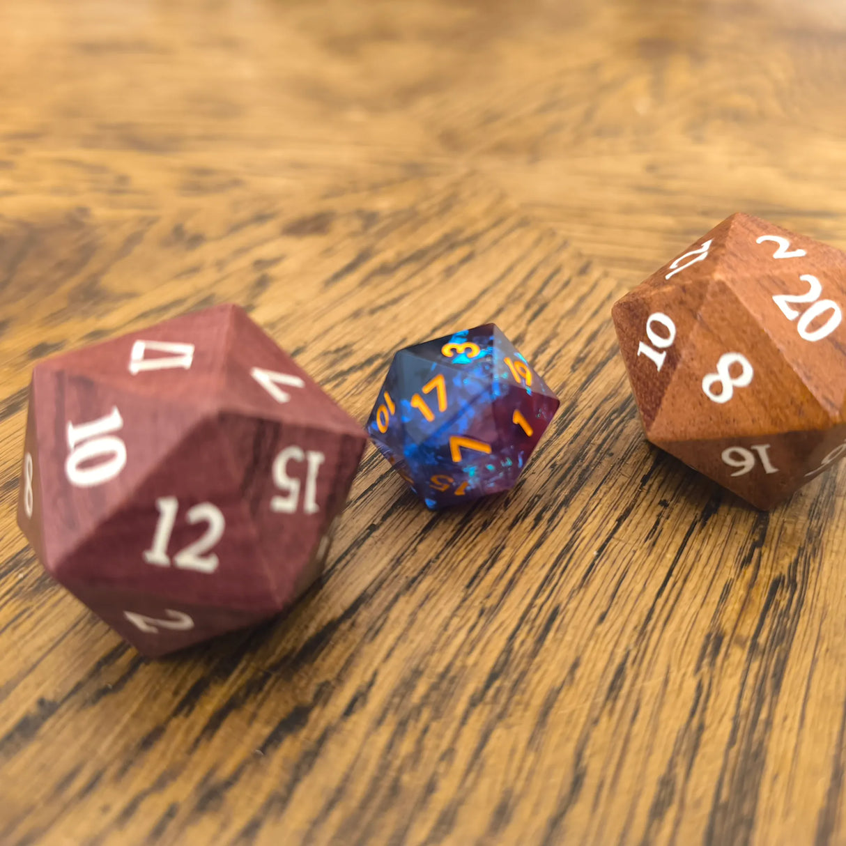 Oversized 33mm wooden D20 dice next to a regular sized D20 for scale