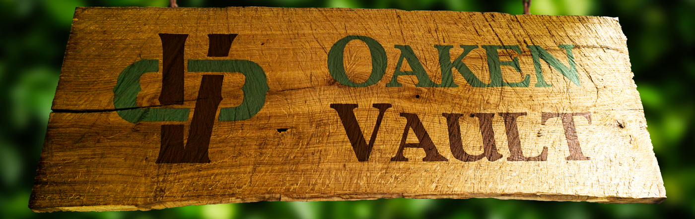Oaken Vault logo on a rustic wooden sign hanging outdoors with a green, leafy background.