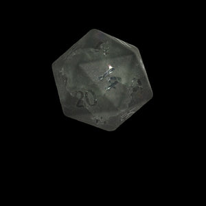 Black polyhedral glass die with '20' frosted