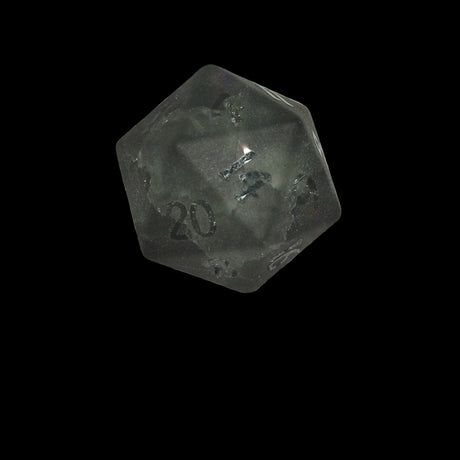Black polyhedral glass die with '20' frosted