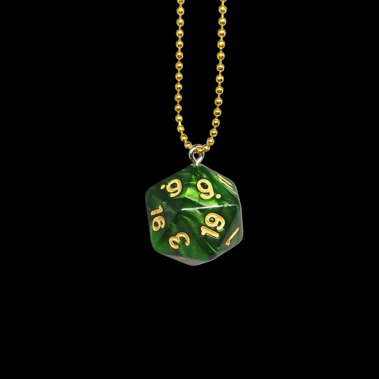 Green die-shaped pendant with gold numbers on a gold chain