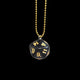 Black polyhedral die pendant with gold numbers on a gold chain