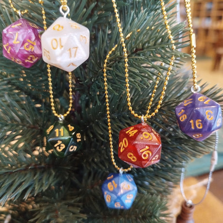 Colorful polyhedral dice ornaments hanging on a Christmas tree.