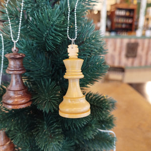 Two chess piece ornaments hanging on a Christmas tree