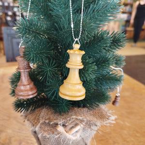 Decorative chess piece ornament on a small Christmas tree