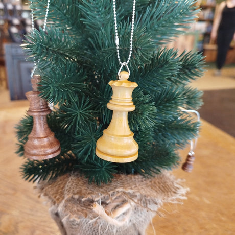 Decorative chess piece ornament on a small Christmas tree